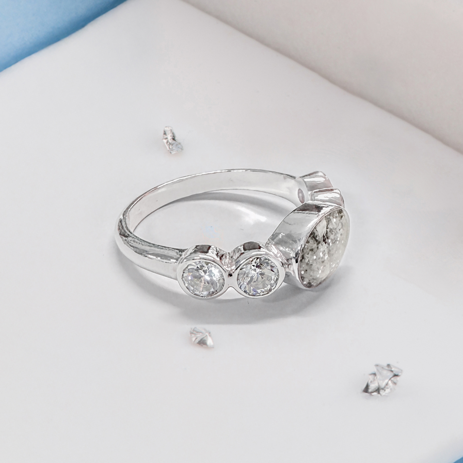 Crystal shoulder oval five stone ashes or hair inlaid ring
