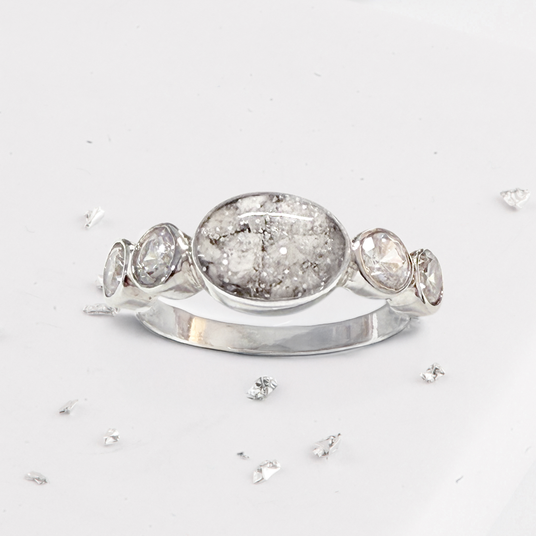 Crystal shoulder oval five stone ashes or hair inlaid ring