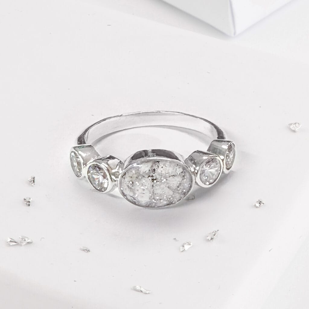 Crystal shoulder oval five stone ashes or hair inlaid ring