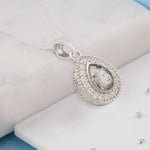 Small teardrop shaped ashes or hair crystal pendant