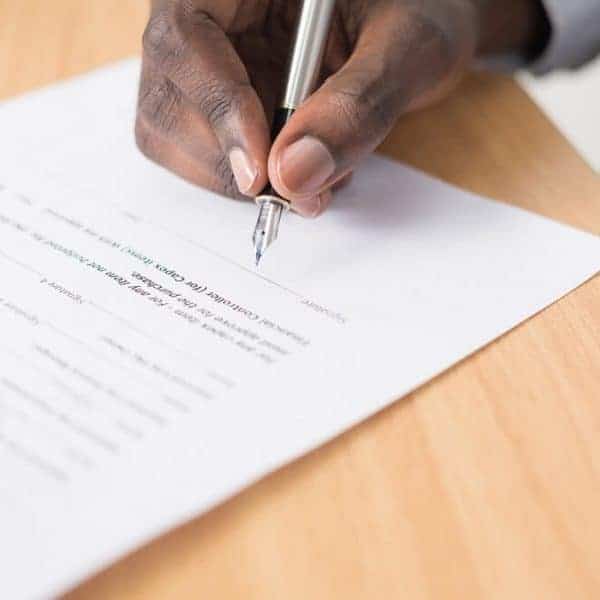 man signing a will